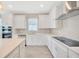 Bright, modern kitchen with white cabinets, quartz countertops, stainless steel appliances, and tile backsplash at 6398 Bradford Woods Drive, Zephyrhills, FL 33542