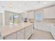 Bright kitchen featuring white cabinetry, stainless steel appliances, a large center island with plenty of storage at 6398 Bradford Woods Drive, Zephyrhills, FL 33542