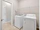 Laundry room with new washer and dryer and wire shelving at 6398 Bradford Woods Drive, Zephyrhills, FL 33542