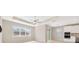 Open-concept living area with a decorative tray ceiling and lots of natural light from the large picture windows at 6398 Bradford Woods Drive, Zephyrhills, FL 33542