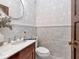 Chic powder room featuring marble tile, a decorative mirror, and a vintage-style vanity; a stylish and functional space at 712 S Newport Ave, Tampa, FL 33606