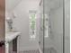 Bright bathroom featuring a glass shower and patterned tile floor at 712 S Newport Ave, Tampa, FL 33606