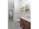 Stylish bathroom showcasing a dark wood vanity, marble countertop, and elegant accents at 712 S Newport Ave, Tampa, FL 33606