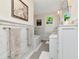 Elegant bathroom features marble walls, decorative tile flooring, and modern fixtures at 712 S Newport Ave, Tampa, FL 33606