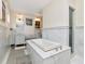 Elegant bathroom featuring a soaking tub with marble surround, and a glass-enclosed shower at 712 S Newport Ave, Tampa, FL 33606