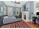Cozy bedroom showcasing blue walls, a decorative fireplace, and multiple windows at 712 S Newport Ave, Tampa, FL 33606