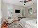 Bedroom showcasing hardwood floors, ample light from shuttered windows, and a cozy chair at 712 S Newport Ave, Tampa, FL 33606
