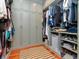 Spacious walk-in closet with custom shelving, ample storage, and hardwood floors covered by a striped rug at 712 S Newport Ave, Tampa, FL 33606