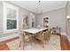 Bright dining room with large windows, modern chandelier, and a table with seating for eight; ideal for formal dinners at 712 S Newport Ave, Tampa, FL 33606