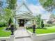 Charming light blue two-story craftsman home with well-maintained lawn, landscaping, and welcoming front porch at 712 S Newport Ave, Tampa, FL 33606
