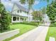 Charming light blue craftsman-style house with well-maintained landscaping and brick paver walkway to front door at 712 S Newport Ave, Tampa, FL 33606