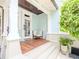 Inviting front porch with classic white columns, a wooden deck, and relaxing seating area at 712 S Newport Ave, Tampa, FL 33606