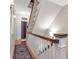 Inviting staircase featuring hardwood floors, white railings, and an oriental rug at 712 S Newport Ave, Tampa, FL 33606