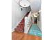Hallway with stairs and patterned carpet runner at 712 S Newport Ave, Tampa, FL 33606