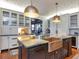 Well-equipped kitchen with a copper farmhouse sink, an island with bar seating, and lots of storage; perfect for entertaining guests at 712 S Newport Ave, Tampa, FL 33606