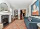 Inviting living room features a fireplace, plush blue sofa, and stylish decor, perfect for relaxing and entertaining guests at 712 S Newport Ave, Tampa, FL 33606