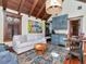 Cozy living room area with hardwood floors, wooden ceiling beams, and wet bar at 712 S Newport Ave, Tampa, FL 33606