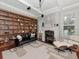 Elegant living room boasts a custom built-in bookcase, modern lighting, fireplace, and comfortable seating area at 712 S Newport Ave, Tampa, FL 33606