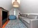 Cozy attic living room with gray leather couches, a large beanbag, and an eye-catching rug at 712 S Newport Ave, Tampa, FL 33606