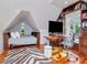 Multi-purpose attic with a comfortable bed, home office, and beautiful zebra rug at 712 S Newport Ave, Tampa, FL 33606