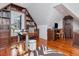 Attic home office with a built-in bookcase, hardwood floors, and two work stations at 712 S Newport Ave, Tampa, FL 33606