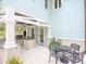 Outdoor kitchen with built-in grill, countertops, dining area, and a charming pergola at 712 S Newport Ave, Tampa, FL 33606