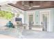 Outdoor kitchen with granite counters, stainless grill, ceiling fan, and seating area at 712 S Newport Ave, Tampa, FL 33606