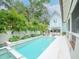 Beautiful pool area with lush landscaping, jacuzzi, and outdoor bar near a lovely blue home at 712 S Newport Ave, Tampa, FL 33606