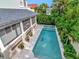 Aerial view of a home's backyard with a beautiful pool and lush landscaping at 712 S Newport Ave, Tampa, FL 33606
