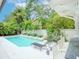 Refreshing pool surrounded by lush landscaping and lounge chairs, perfect for relaxing at 712 S Newport Ave, Tampa, FL 33606