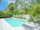 Beautiful pool area enhanced by tropical foliage and comfortable lounge chairs for relaxation at 712 S Newport Ave, Tampa, FL 33606