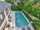 Aerial view of a backyard featuring a pool, jacuzzi, and lush landscaping near a lovely home at 712 S Newport Ave, Tampa, FL 33606
