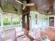 Inviting front porch with wood floors, comfortable seating, and ceiling fans for relaxing outdoor living at 712 S Newport Ave, Tampa, FL 33606