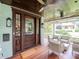 Spacious porch featuring a wood ceiling and flooring, and ample seating perfect for relaxing at 712 S Newport Ave, Tampa, FL 33606