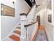 Bright staircase featuring natural wood stairs, white railings, and a decorative blue runner at 712 S Newport Ave, Tampa, FL 33606