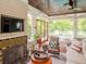 Beautiful sunroom with a fireplace, wood floors, a ceiling fan and large windows at 712 S Newport Ave, Tampa, FL 33606