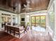 Stylish sunroom with wood floors, ample seating, and natural light at 712 S Newport Ave, Tampa, FL 33606