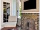 Cozy sunroom featuring a fireplace with decorative tile, and comfortable lounge seating at 712 S Newport Ave, Tampa, FL 33606