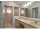 This bathroom has double sinks, a large mirror, and a walk-in shower with glass block windows at 717 Lighthouse Dr, Tarpon Springs, FL 34689