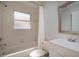 Full bathroom featuring a shower-tub combo, window, and vanity with sink at 717 Lighthouse Dr, Tarpon Springs, FL 34689