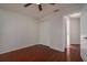 Simple bedroom featuring hardwood floors, a ceiling fan, and a closet with bifold doors at 717 Lighthouse Dr, Tarpon Springs, FL 34689