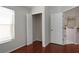 Bedroom boasts hardwood floors, a closet, and easy access to the nearby kitchen at 717 Lighthouse Dr, Tarpon Springs, FL 34689