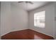 Cozy bedroom showcasing neutral walls, hardwood floors, and a bright window at 717 Lighthouse Dr, Tarpon Springs, FL 34689