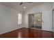 This bedroom is filled with natural light, has a sliding door to the porch, and has wood floors at 717 Lighthouse Dr, Tarpon Springs, FL 34689