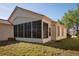 Rear exterior showcasing a screened-in porch and serene backyard at 717 Lighthouse Dr, Tarpon Springs, FL 34689