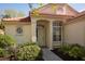 Inviting front entrance with a round window and a meticulously kept garden at 717 Lighthouse Dr, Tarpon Springs, FL 34689