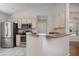 Kitchen featuring stainless steel appliances, light cabinets, and a breakfast bar at 717 Lighthouse Dr, Tarpon Springs, FL 34689
