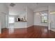 Bright, open living room with high ceilings, hardwood flooring, and an open layout to the kitchen at 717 Lighthouse Dr, Tarpon Springs, FL 34689