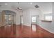 Bright, open living room with high ceilings, and hardwood flooring, and natural light from sliding glass doors at 717 Lighthouse Dr, Tarpon Springs, FL 34689