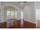 Bright living room with hardwood floors and sliding glass doors to the outdoor space at 717 Lighthouse Dr, Tarpon Springs, FL 34689